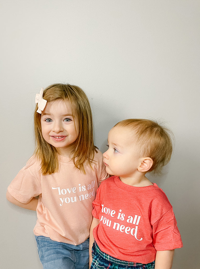 Love Is All You Need Peach Baby Onesie